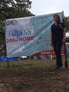 Kathlyn Smith next to Euless 200th Home sign