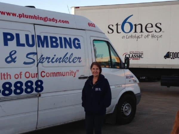 Kathlyn Smith waits by her van on her way to a 6 Stones sponsored charity home renovation