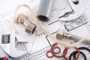 Pipe fittings and wrenches on blueprints