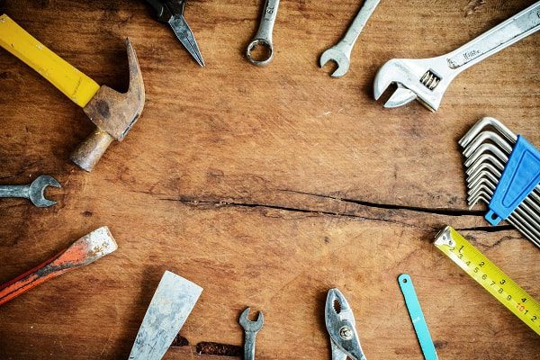 Set of work tools on old grunge wooden work bench